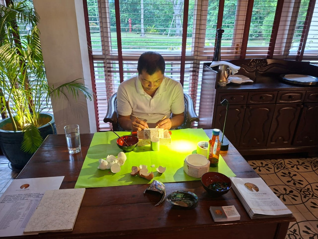Master artisan pressing eggshell mosaic by hand at the Stocker Studio atelier in Siem Reap