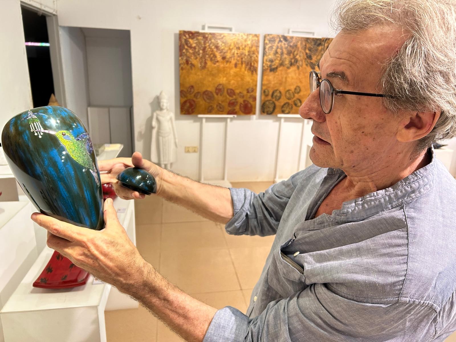 Eric Stocker examining a finished lacquer piece — the trained eye of a Mobilier National restorer
