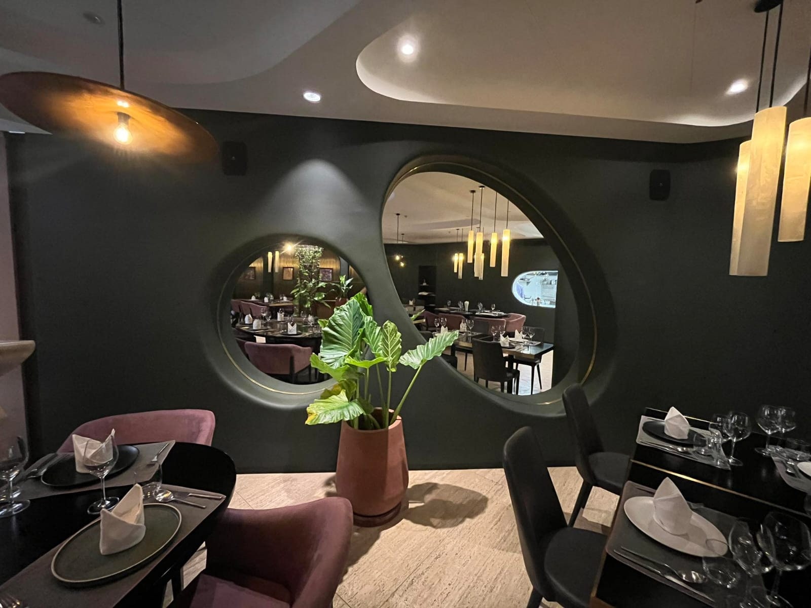 Lacquer wall details with circular mirror inserts in a restaurant interior — a Stocker Studio commission