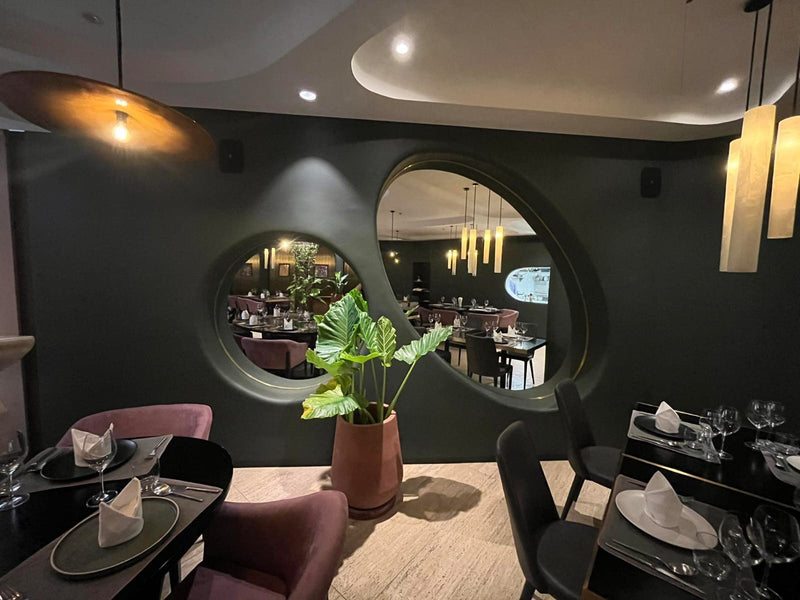 Lacquer wall details with circular mirror inserts in a restaurant interior — a Stocker Studio commission