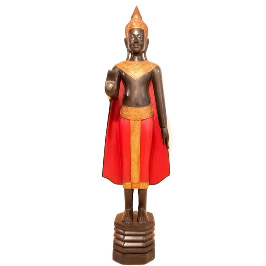 Statue of a figure in traditional attire with a red garment and gold accents on a white background