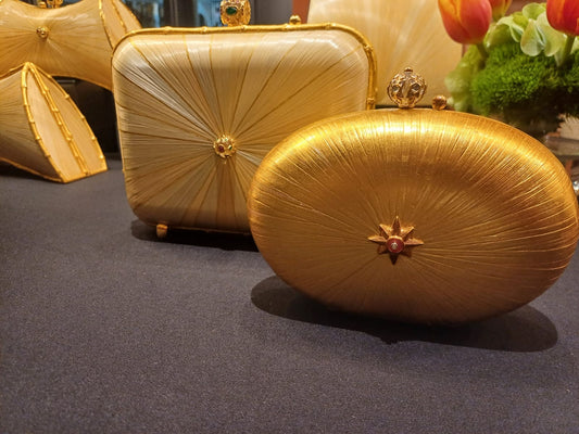Stocker Studio Oval clutch with star clasp — golden rye-straw marquetry sunburst