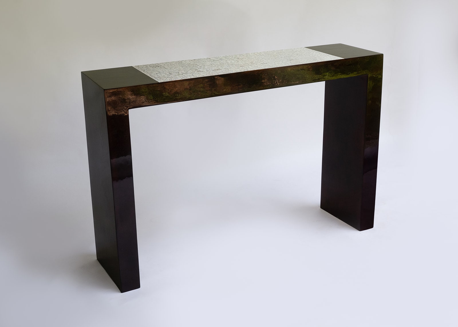 Stocker Studio lacquer console with eggshell band — three-quarter view showing copper-toned top edge