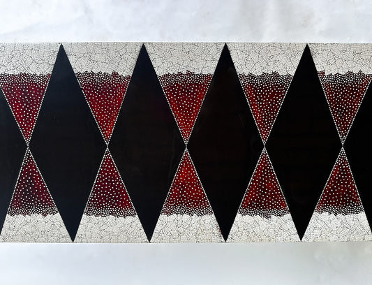 Detail of Stocker Studio lacquer console with black diamonds on red eggshell ground, framed by white eggshell mosaic bands