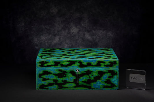 SIGLO × Eric Stocker ATOLL humidor — closed studio view, abstract emerald, lapis and obsidian pigmented lacquer