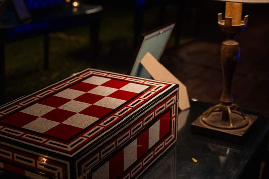 SIGLO × Eric Stocker LE ROYAL humidor — red and white eggshell-mosaic checkerboard with Greek-key border