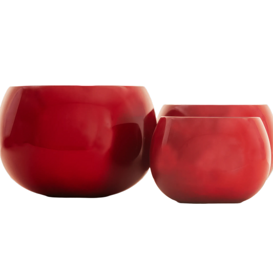 Three red ceramic bowls on a white background